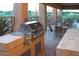 Outdoor kitchen and dining area equipped with a stainless steel grill and tile countertops at 9620 E Roadrunner Dr, Scottsdale, AZ 85262
