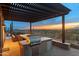 Outdoor kitchen and dining area under a pergola, with stainless grill and stunning mountain views at 9620 E Roadrunner Dr, Scottsdale, AZ 85262