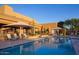 Refreshing community pool with lounge chairs, umbrellas and desert landscaping, perfect for relaxation at 9620 E Roadrunner Dr, Scottsdale, AZ 85262