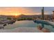 Resort-style pool with cascading rock features and lush desert landscaping overlooks mountain views at 9620 E Roadrunner Dr, Scottsdale, AZ 85262