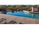 Inviting community pool with lounge chairs and manicured landscaping for relaxation and leisure at 9620 E Roadrunner Dr, Scottsdale, AZ 85262