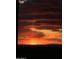 Dramatic sunset with shades of red and orange painting the cloudy sky at 9620 E Roadrunner Dr, Scottsdale, AZ 85262