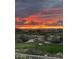 Scenic golf course view with a vibrant sunset over the mountain landscape at 9620 E Roadrunner Dr, Scottsdale, AZ 85262