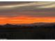 Dramatic sunset view over the mountain range, with colorful sky and silhouette of the landscape at 9620 E Roadrunner Dr, Scottsdale, AZ 85262