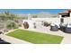 Relaxing backyard featuring artificial turf, a spa, and desert landscaping offering a serene outdoor experience at 9858 E South Bend Dr, Scottsdale, AZ 85255