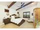 Vaulted bedroom with beamed ceiling, decorative light fixtures and carpeted floors at 9858 E South Bend Dr, Scottsdale, AZ 85255