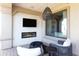 Charming covered patio boasts a modern fireplace, wall-mounted TV, and comfortable seating area for relaxation at 9858 E South Bend Dr, Scottsdale, AZ 85255
