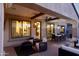 Inviting covered patio featuring comfortable seating, brick flooring, and stylish lighting for outdoor living and dining at 9858 E South Bend Dr, Scottsdale, AZ 85255