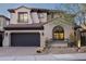 Elegant two-story home boasts desert landscaping, a dark garage door and a beautiful clay tile roof at 9858 E South Bend Dr, Scottsdale, AZ 85255