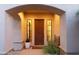 Inviting front entry featuring a solid wood door flanked by sidelights and a covered archway at 9858 E South Bend Dr, Scottsdale, AZ 85255