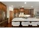 Open kitchen with marble countertop island, stainless steel appliances, and custom wood cabinets at 9858 E South Bend Dr, Scottsdale, AZ 85255
