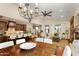 Spacious living area with a dining table, connecting kitchen, hardwood floors, and a ceiling fan at 9858 E South Bend Dr, Scottsdale, AZ 85255