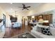Bright living space featuring hardwood floors, ceiling fan, dining area, and connecting kitchen at 9858 E South Bend Dr, Scottsdale, AZ 85255