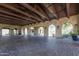 Open-air pavilion with rustic wood beams, brick floors, arched entryways, and decorative chandeliers at 9858 E South Bend Dr, Scottsdale, AZ 85255