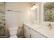 This bathroom boasts a double sink vanity, elegant lighting, and luxurious marble tile in the shower at 1055 W Dragoon Ave, Mesa, AZ 85210