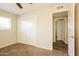 This bedroom offers carpet flooring, double closet and view of the entrance to the next room at 1055 W Dragoon Ave, Mesa, AZ 85210