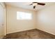 Inviting bedroom featuring carpet flooring, ceiling fan, a window and closet for organized storage at 1055 W Dragoon Ave, Mesa, AZ 85210