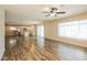 Bright, open floor plan with wood-look flooring, connecting the living room to the modern kitchen at 1055 W Dragoon Ave, Mesa, AZ 85210