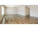 Spacious living room featuring wood-look tile flooring and a modern ceiling fan at 1055 W Dragoon Ave, Mesa, AZ 85210