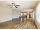 Open-concept living area with wood-look floors flowing into the kitchen with stainless appliances at 1055 W Dragoon Ave, Mesa, AZ 85210