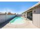 Backyard pool with clean water, a surrounding concrete patio, and covered patio and block fence at 1055 W Dragoon Ave, Mesa, AZ 85210