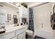 Bathroom featuring a vanity, toilet, and bathtub with a gray and white striped shower curtain at 10855 W Buccaneer Dr, Sun City, AZ 85351