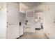 Bright bathroom featuring a vanity and a makeup area in addition to a bathroom in the background at 10855 W Buccaneer Dr, Sun City, AZ 85351