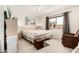 Bright main bedroom with a large window and ceiling fan at 10855 W Buccaneer Dr, Sun City, AZ 85351
