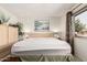 Bright bedroom featuring a bed with a light wood headboard and nature-themed wall art at 10855 W Buccaneer Dr, Sun City, AZ 85351
