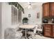 Cozy breakfast nook with a round table and chairs near a window at 10855 W Buccaneer Dr, Sun City, AZ 85351