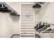 Walk-in closet featuring rods with hangers and built-in shelving for optimal storage solutions at 10855 W Buccaneer Dr, Sun City, AZ 85351