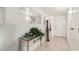 Inviting foyer features tile flooring, a mirrored accent wall, and contemporary decor at 10855 W Buccaneer Dr, Sun City, AZ 85351
