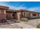 Charming single-story home featuring desert landscaping and a secure gated entrance at 10855 W Buccaneer Dr, Sun City, AZ 85351