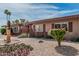 Quaint desert landscape with a decorative eagle statue, native cactus, and palm trees accenting this lovely home at 10855 W Buccaneer Dr, Sun City, AZ 85351