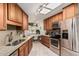 Functional kitchen featuring granite counters, stainless appliances, and breakfast nook access at 10855 W Buccaneer Dr, Sun City, AZ 85351