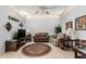 Comfortable living room featuring tile flooring, a ceiling fan, and neutral paint tones at 10855 W Buccaneer Dr, Sun City, AZ 85351