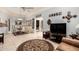 Spacious living room with a round rug, TV, and access to dining area and other rooms at 10855 W Buccaneer Dr, Sun City, AZ 85351