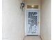 Close-up of the front door featuring a decorative security screen with desert-themed artwork at 1366 E Desert Fern Trl, Casa Grande, AZ 85122