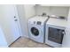 Well-lit laundry room with side-by-side washer and dryer units at 1366 E Desert Fern Trl, Casa Grande, AZ 85122