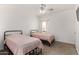 Well-lit bedroom featuring two beds and carpet flooring, creating a welcoming atmosphere at 1472 E Avenida Kino --, Casa Grande, AZ 85122