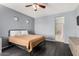 Cozy bedroom with gray walls, dark wood floors, and a view to the bathroom at 1472 E Avenida Kino --, Casa Grande, AZ 85122