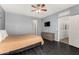 Serene bedroom featuring neutral decor, dark wood floors, and an ensuite bathroom entrance at 1472 E Avenida Kino --, Casa Grande, AZ 85122