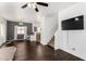 Cozy living room with hardwood floors, a ceiling fan, natural light, and a staircase view at 1472 E Avenida Kino --, Casa Grande, AZ 85122