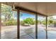 Spacious covered back patio offers serene views of the beautifully landscaped backyard and natural light at 15136 W Cactus Ridge Way, Surprise, AZ 85374