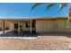 Charming backyard featuring a covered patio, desert landscaping, and a seamless blend of indoor/outdoor living at 15136 W Cactus Ridge Way, Surprise, AZ 85374