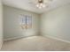 Carpeted bedroom featuring a window, neutral walls, and ceiling fan with light at 15136 W Cactus Ridge Way, Surprise, AZ 85374