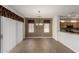 Cozy dining room features tile floors, modern chandelier, and stylish window treatments at 15136 W Cactus Ridge Way, Surprise, AZ 85374