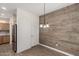 Eat-in kitchen space featuring rustic wood accent wall and pantry door at 15136 W Cactus Ridge Way, Surprise, AZ 85374