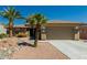 Charming home featuring desert landscaping, a two-car garage, and beautiful palm trees at 15136 W Cactus Ridge Way, Surprise, AZ 85374