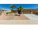 Charming home featuring desert landscaping with gravel and rock accents, and mature palm trees at 15136 W Cactus Ridge Way, Surprise, AZ 85374